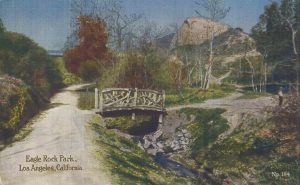This rustic bridge crossed the stream in Huntington’s park below the Eagle Rock. Visible on the left above center is the bridge that led from Eagle Rock to Pasadena. This was the easiest crossing of the highly variable stream seen in the foreground. The stream still flows in the open through the MWD land, under the dump road and behind the commercial buildings on the east side of Figueroa St just below the 134 Freeway exit bridge. (ERVHS)