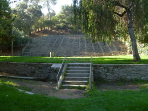 The upper park retaining wall and Sylvan Theater are shown in 2010. The grey paint used to cover graffiti though well intended, obscures the beauty of the masonry and,ironically, provides a better canvas for more graffiti.-Photo by Eric Warren, 10-13-2010.