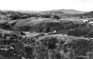 Traffic was heavy on the road to Pasadena, probably on opening day of the Arroyo Seco Bridge. Traffic from Highland Park enters from middle left and Eagle Rock on middle right. They are heading across the bridge to Pasadena lower left. (ERVHS)