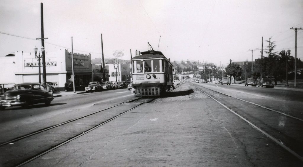 The streetcar is stopped at Argus Drive. We look west in March of 1948 just before the tracks were removed. The building to the left was incorporated in the Piller’s store. The Women’s Twentieth Century Club building is in the foliage to the right. (Alan Weeks photograph)