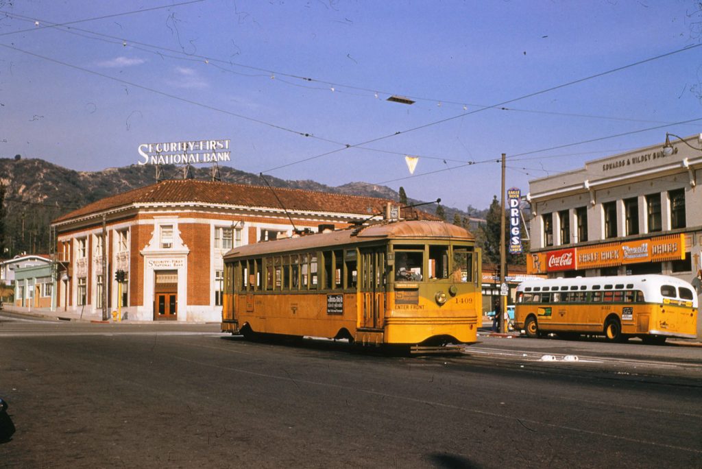 The 1409 car poised to depart from the new end of the line in 1955. The bus that would replace the 5 Line is to the right, in front of the Rexall emblazoned Edwards and Wildey Building. To the left of the car is the since demolished Security Bank Building. (Alan Weeks photograph)