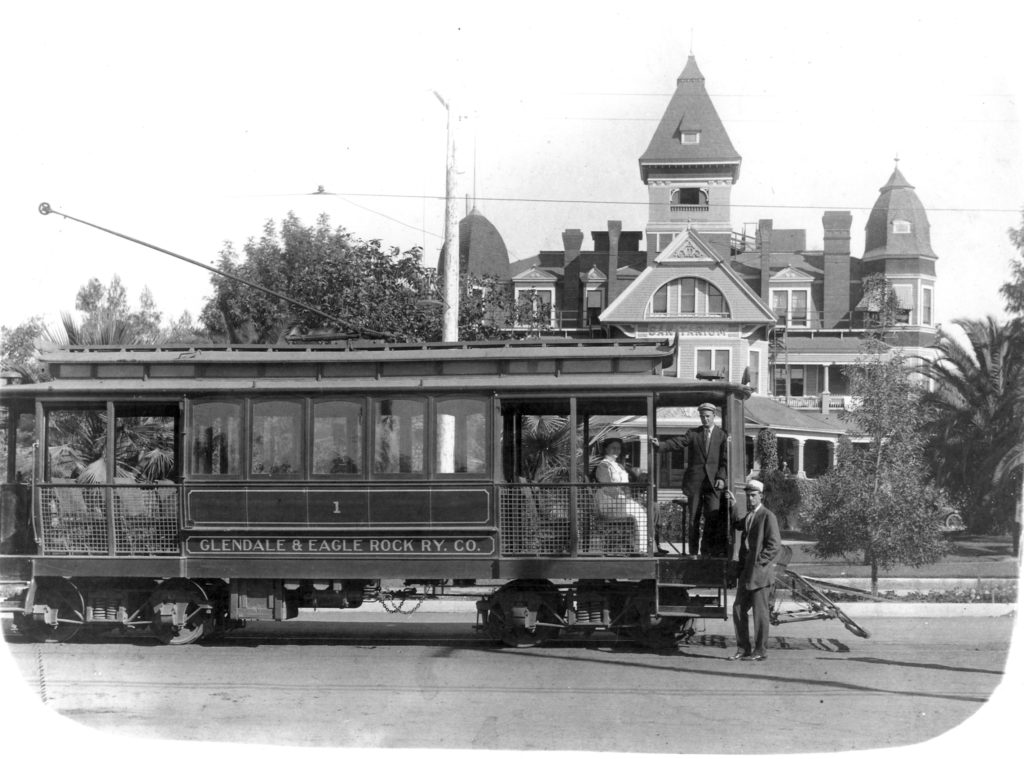 Frank Hilliard posed in the door of the streetcar on Broadway in Glendale headed toward Eagle Rock. E. D Goode’s son Ray stands by on the street. The building in the background was the Glendale Sanitarium, ancestor of todays Glendale Adventist Medical Center. It was built as the Glendale Hotel in the center of Glendale at the height of the boom of the 1880’s. It also served as St. Hilda’s Academy, an Episcopalian High School and the first Union High School, serving Glendale, Eagle Rock and several other small communities. (Glendale Public Library)